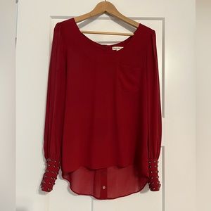 Sheer Blouse with studded cuffs and snaps down the back.